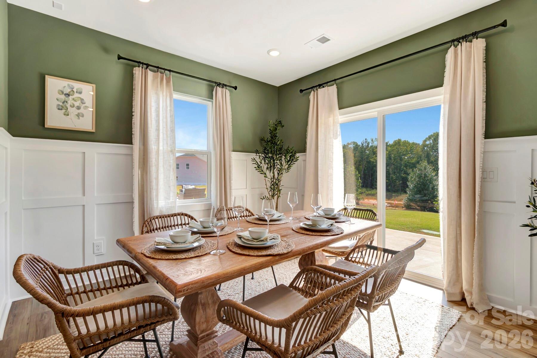 1452 Kate Cecil Way York, SC 29745 - Photo 11 of 27 a view of a dining room with furniture large windows and wooden floor