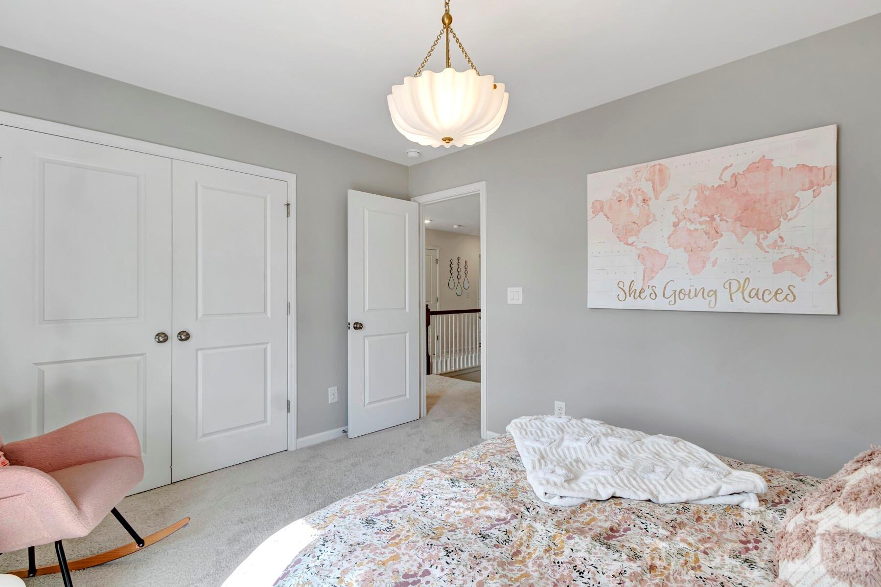 1452 Kate Cecil Way York, SC 29745 - Photo 20 of 27 a bedroom with a bed and a chandelier