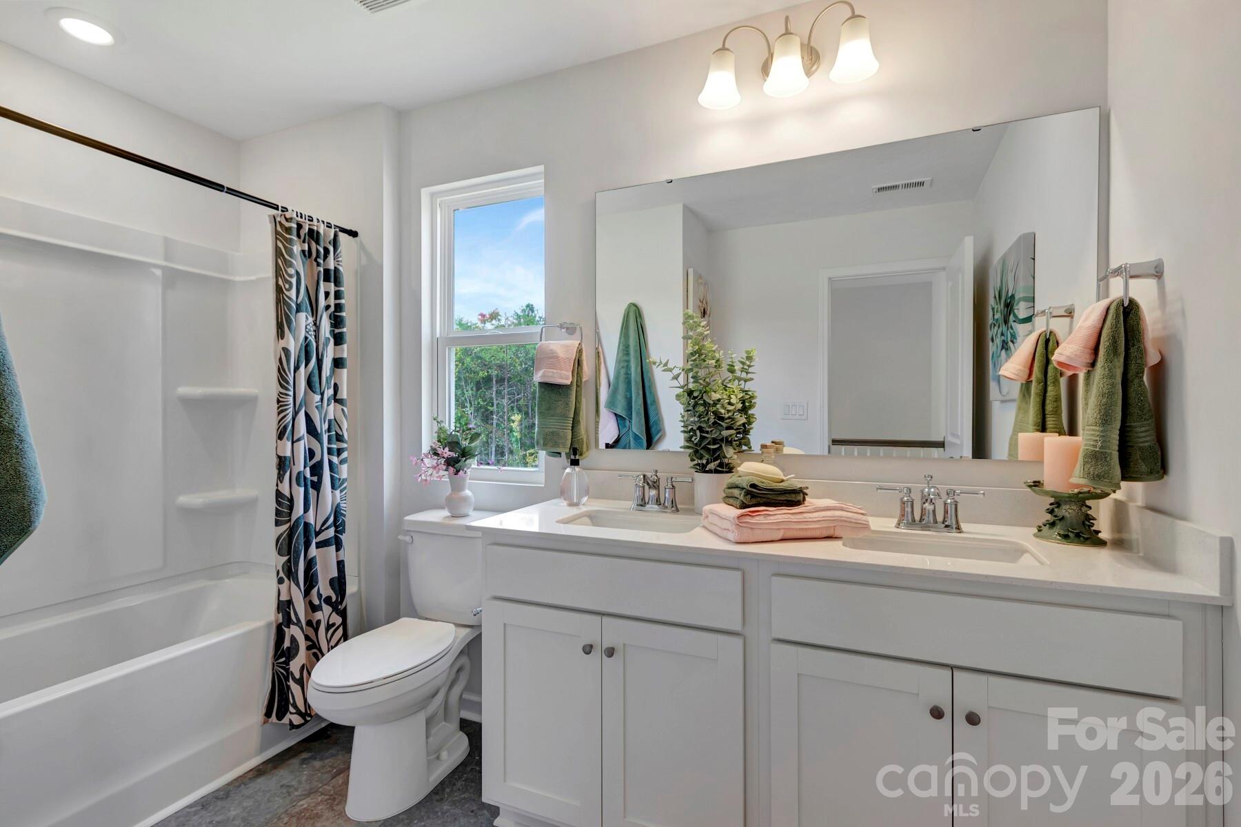 1452 Kate Cecil Way York, SC 29745 - Photo 21 of 27 a bathroom with a double vanity sink toilet mirror and bathtub