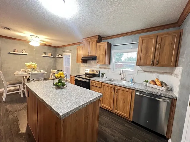 a kitchen with a sink a stove and cabinets