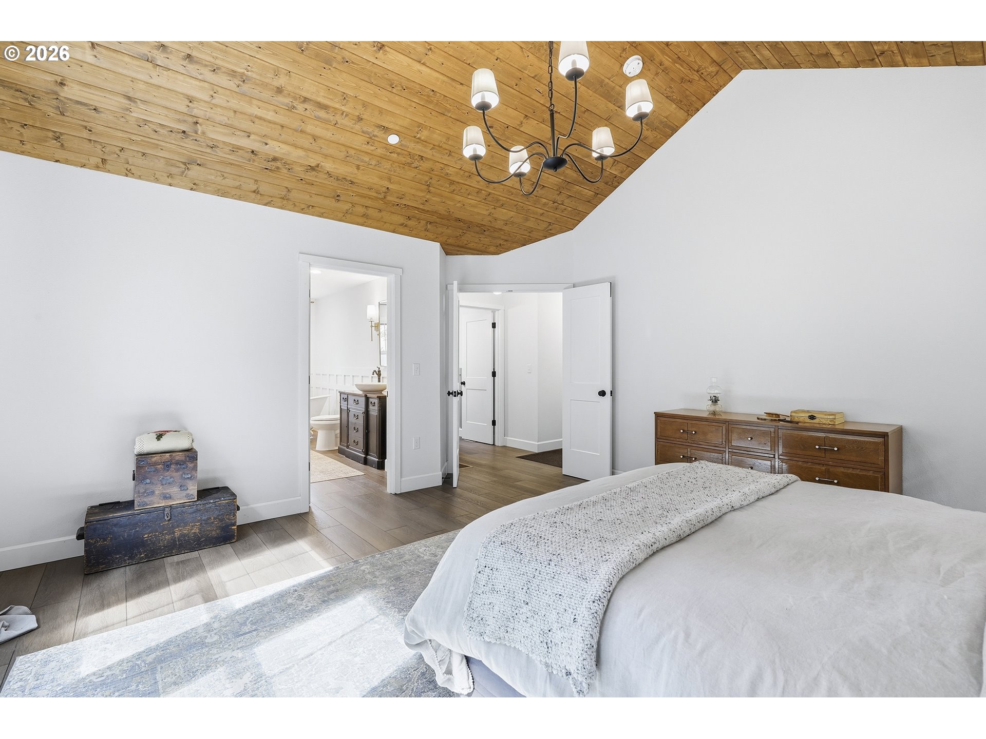 15680 South Wave Road Mulino, OR 97042 - Photo 21 of 43 a bedroom with a bed and a chandelier