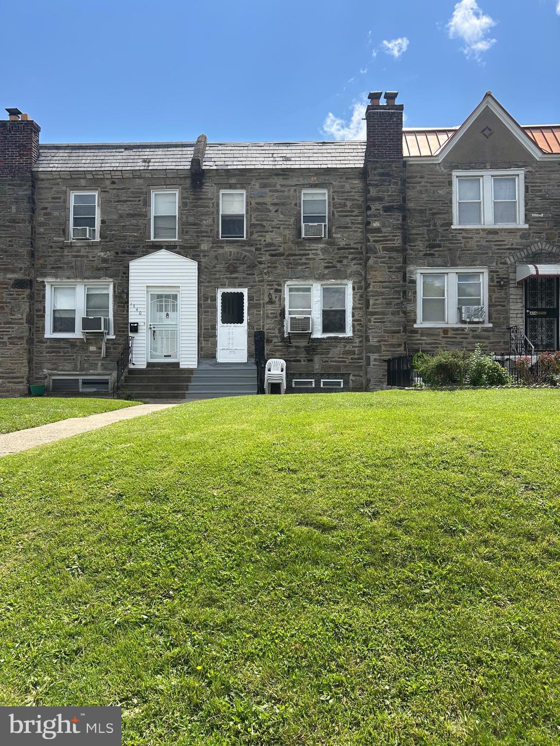 a view of house with yard and front view of a house