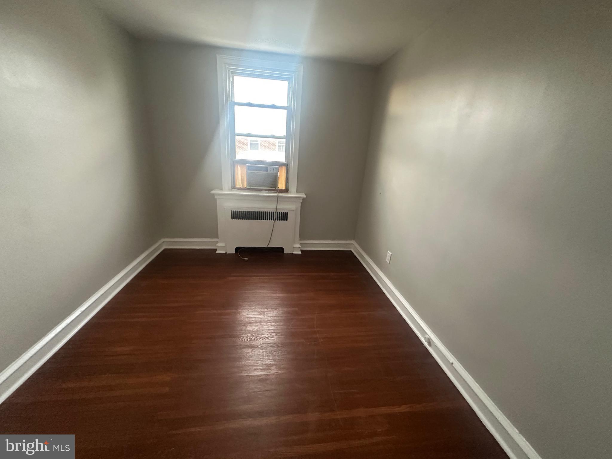 1440 Stirling Street Philadelphia, PA 19149 - Photo 13 of 18 an empty room with wooden floor and windows