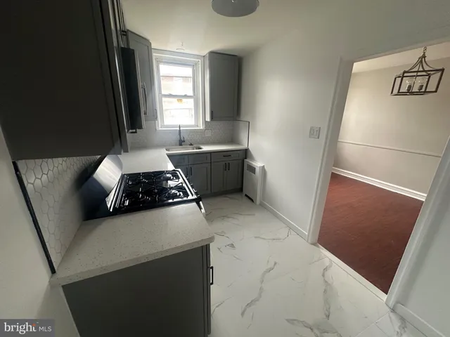 a kitchen with stainless steel appliances granite countertop a sink stove and microwave