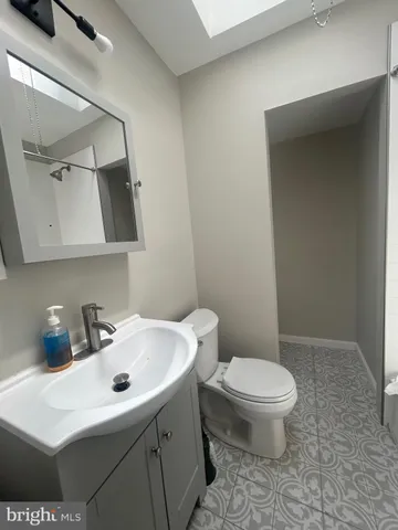 a bathroom with a sink a toilet and vanity