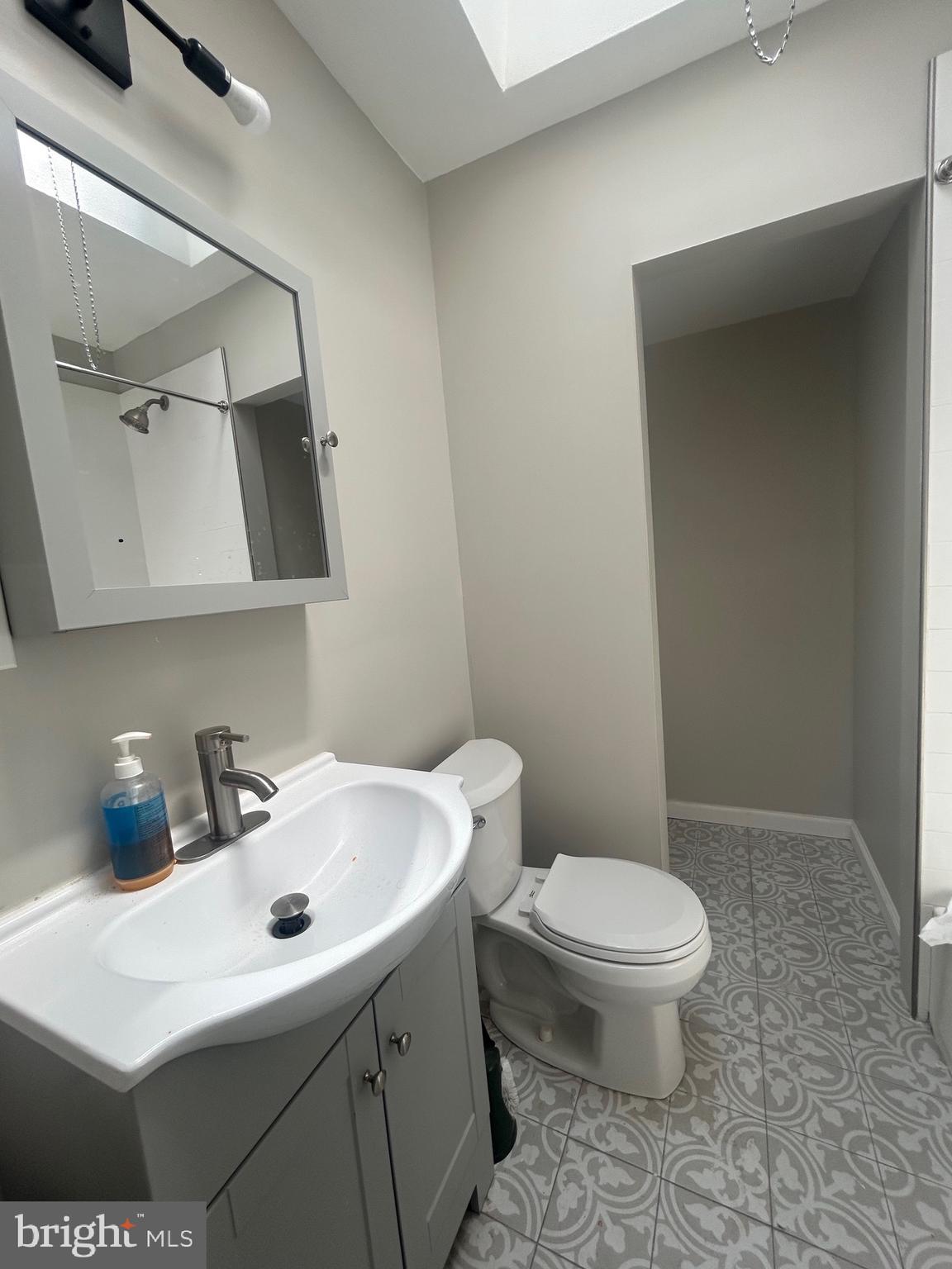 1440 Stirling Street Philadelphia, PA 19149 - Photo 3 of 18 a bathroom with a sink a toilet and vanity