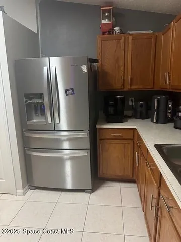 a kitchen with a refrigerator sink and cabinets
