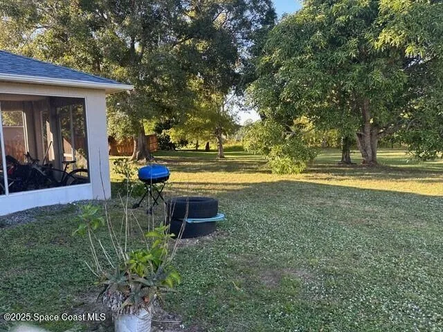 a view of a swimming pool with an outdoor seating and a yard
