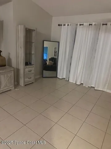 a view of a utility room with cabinets and a couch