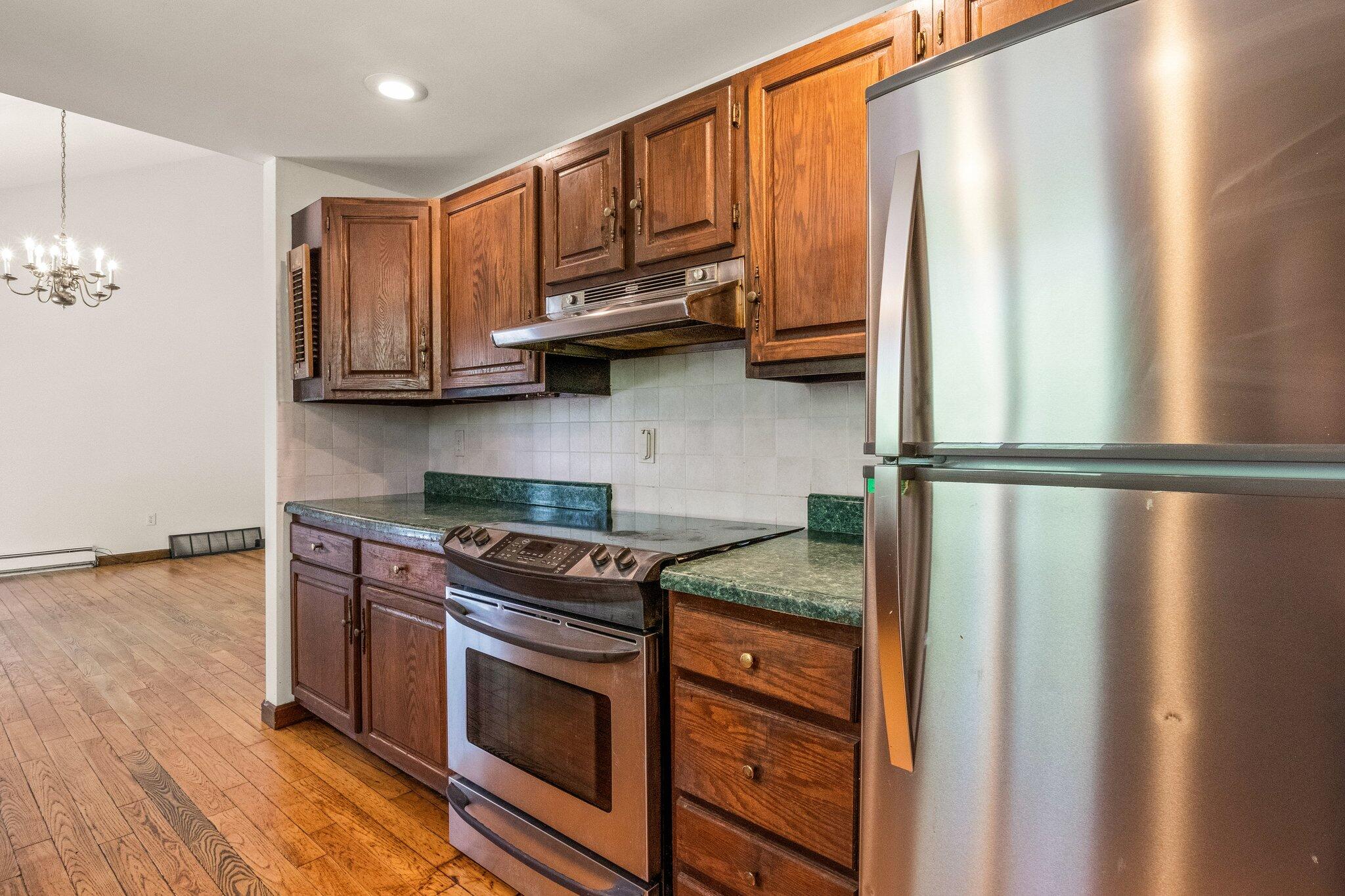 472 Elliott Road Centerville, MA 02632 - Photo 14 of 36 a kitchen with stainless steel appliances granite countertop a refrigerator stove and sink