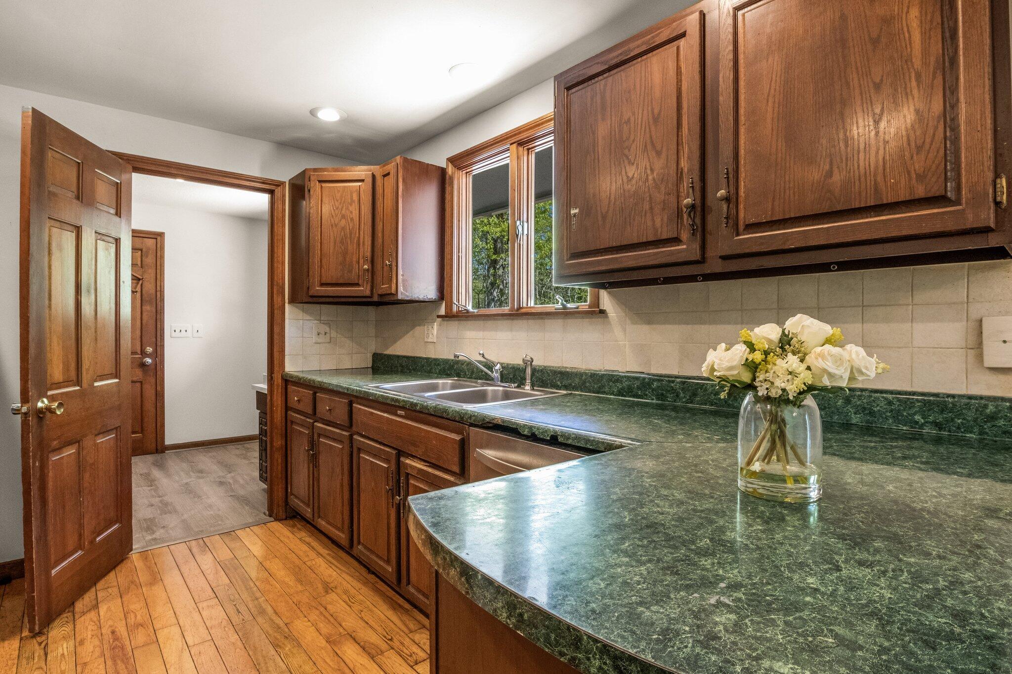 472 Elliott Road Centerville, MA 02632 - Photo 15 of 36 a kitchen with kitchen island granite countertop a sink cabinets and stainless steel appliances