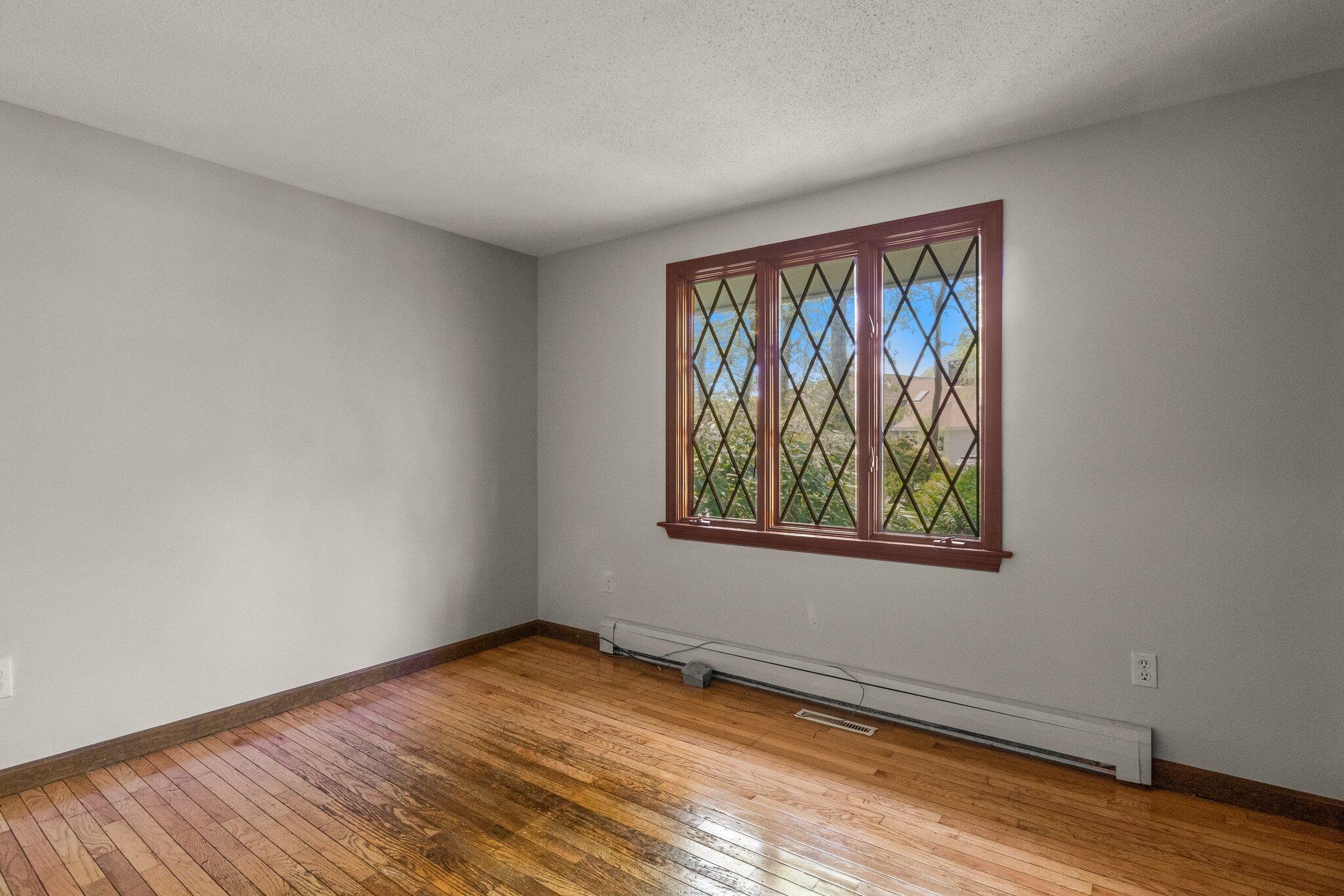 472 Elliott Road Centerville, MA 02632 - Photo 19 of 36 a view of an empty room with window and wooden floor