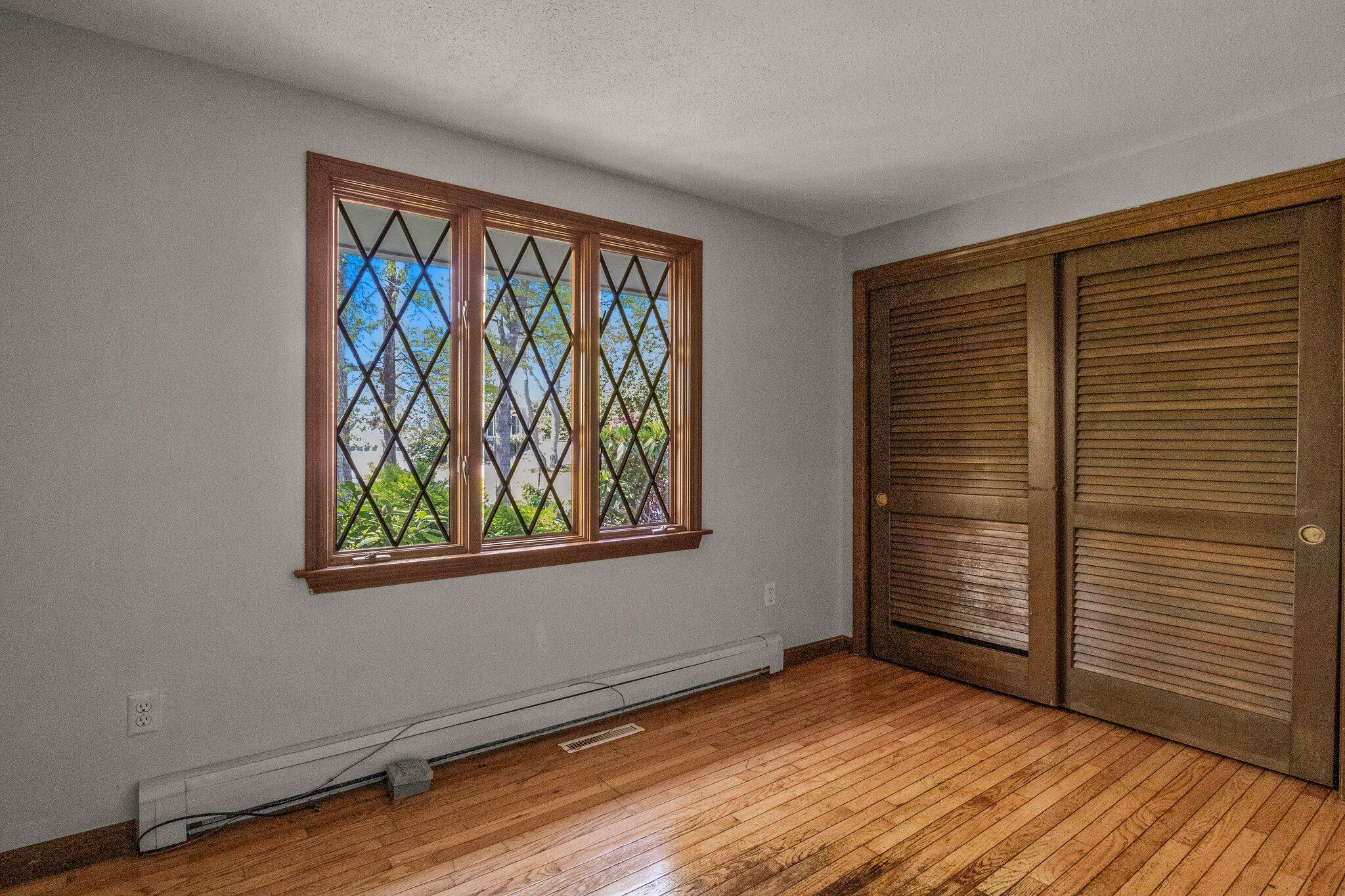 472 Elliott Road Centerville, MA 02632 - Photo 20 of 36 a view of an empty room with wooden floor and a window