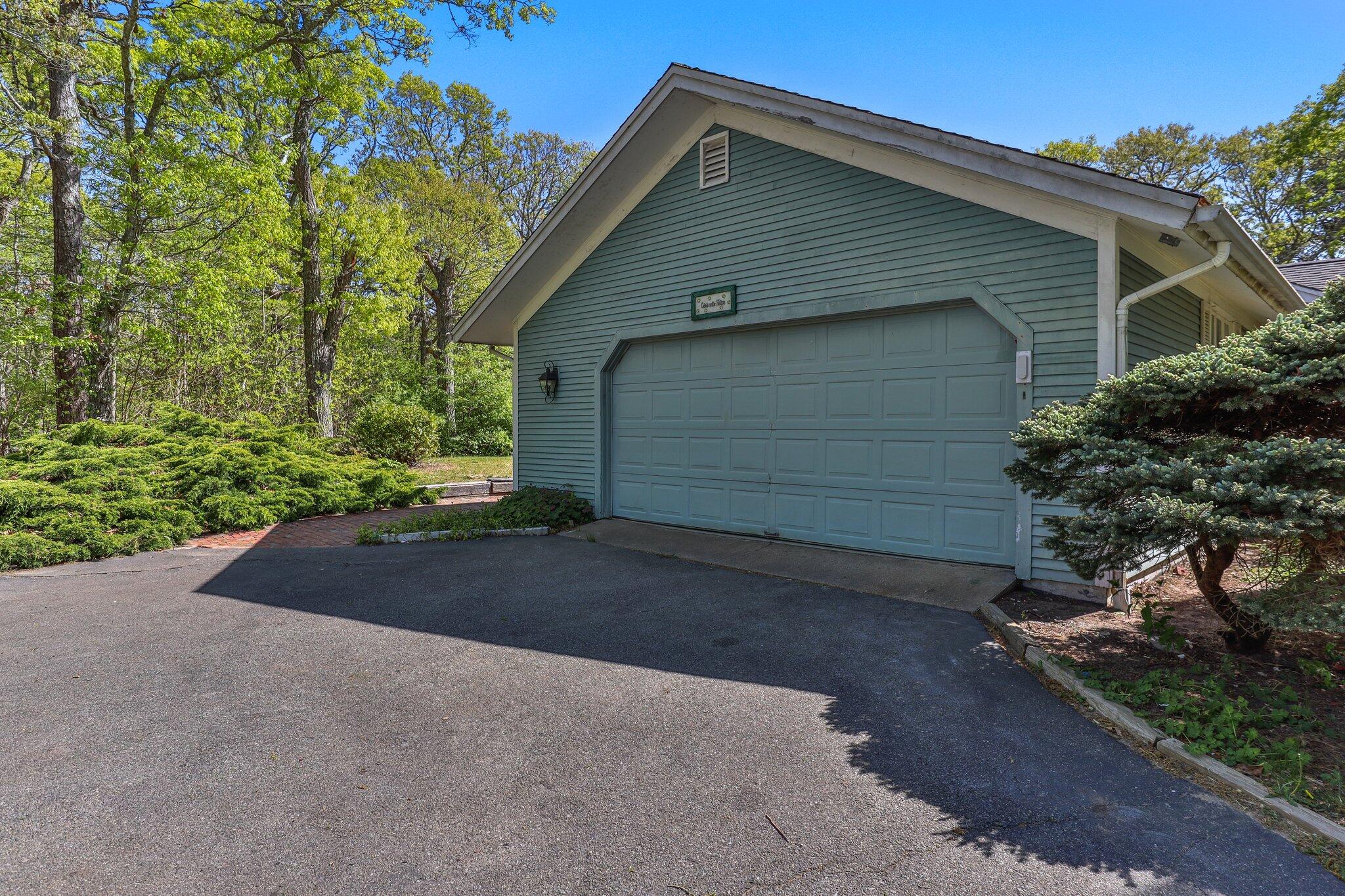 472 Elliott Road Centerville, MA 02632 - Photo 28 of 36 a front view of a house with a yard and garage