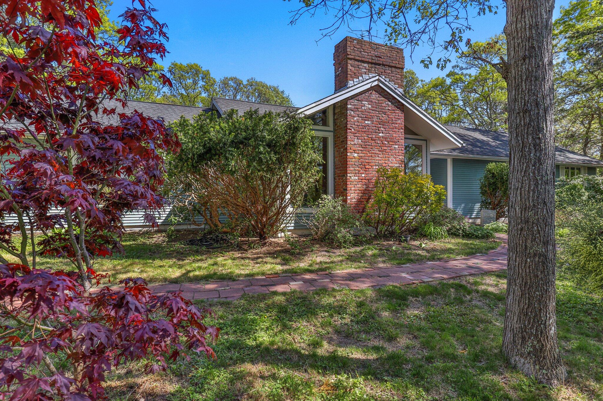 472 Elliott Road Centerville, MA 02632 - Photo 3 of 36 a front view of a house with a yard