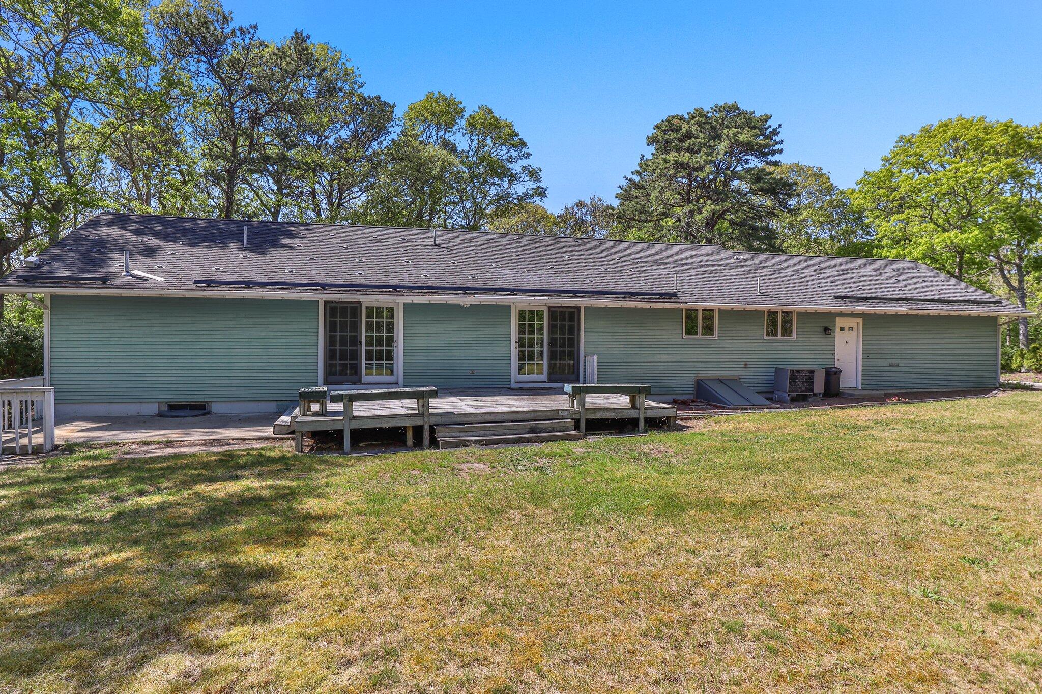 472 Elliott Road Centerville, MA 02632 - Photo 31 of 36 a view of a house with a swimming pool and a yard