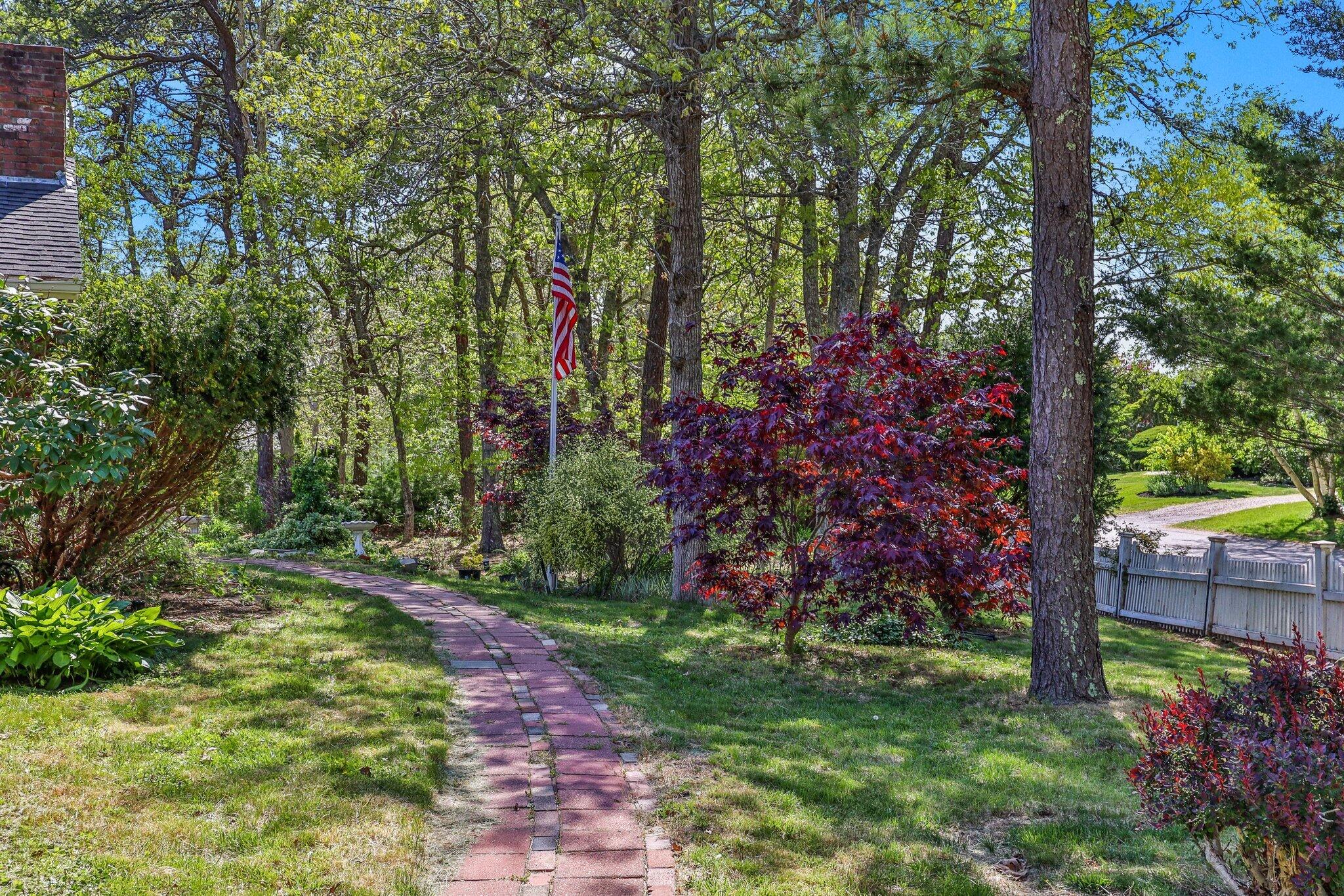 472 Elliott Road Centerville, MA 02632 - Photo 32 of 36 a view of a backyard with plants and large trees