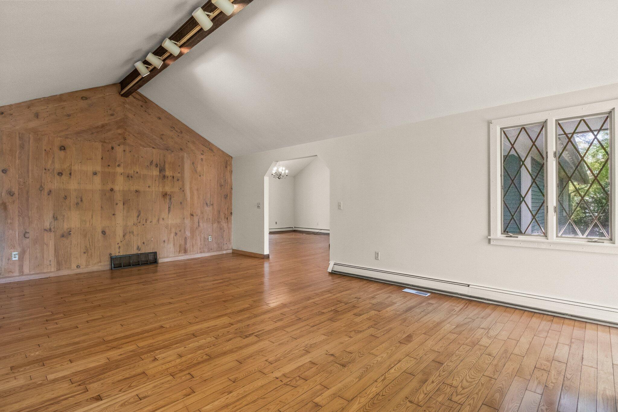 472 Elliott Road Centerville, MA 02632 - Photo 9 of 36 a view of an empty room with wooden floor and a window