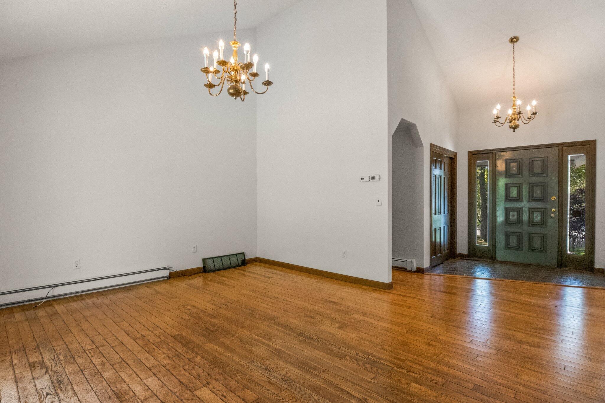 472 Elliott Road Centerville, MA 02632 - Photo 10 of 36 a view of a room with wooden floor and chandelier