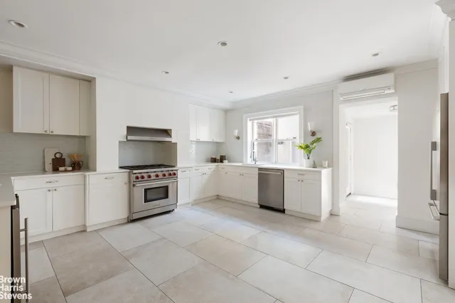 a kitchen with a stove top oven sink and cabinets