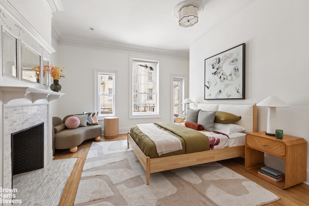 209 West 139th Street Manhattan, NY 10030 - Photo 7 of 14 a spacious bedroom with a bed and a couch