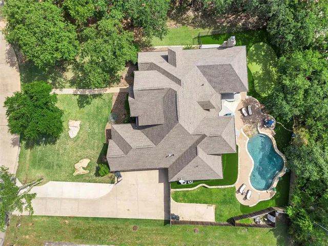 an aerial view of a house with yard swimming pool and outdoor seating