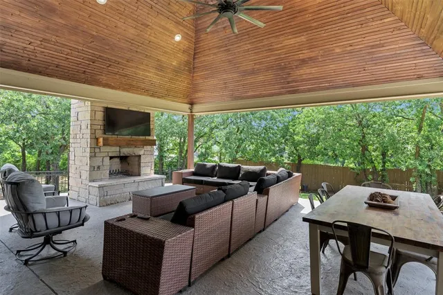 a living room with furniture a flat screen tv and a large window