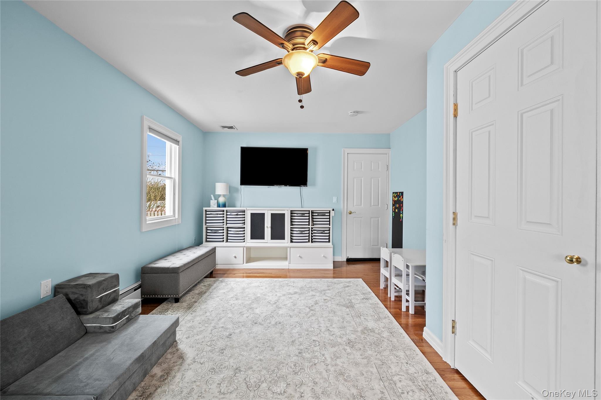 625 Edgewater Road Oakdale, NY 11769 - Photo 29 of 49 Living area featuring wood finished floors and ceiling fan