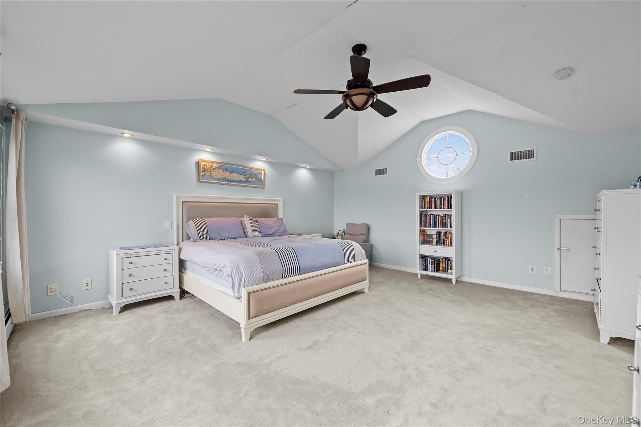 625 Edgewater Road Oakdale, NY 11769 - Photo 33 of 49 Bedroom featuring vaulted ceiling, light carpet, and a ceiling fan