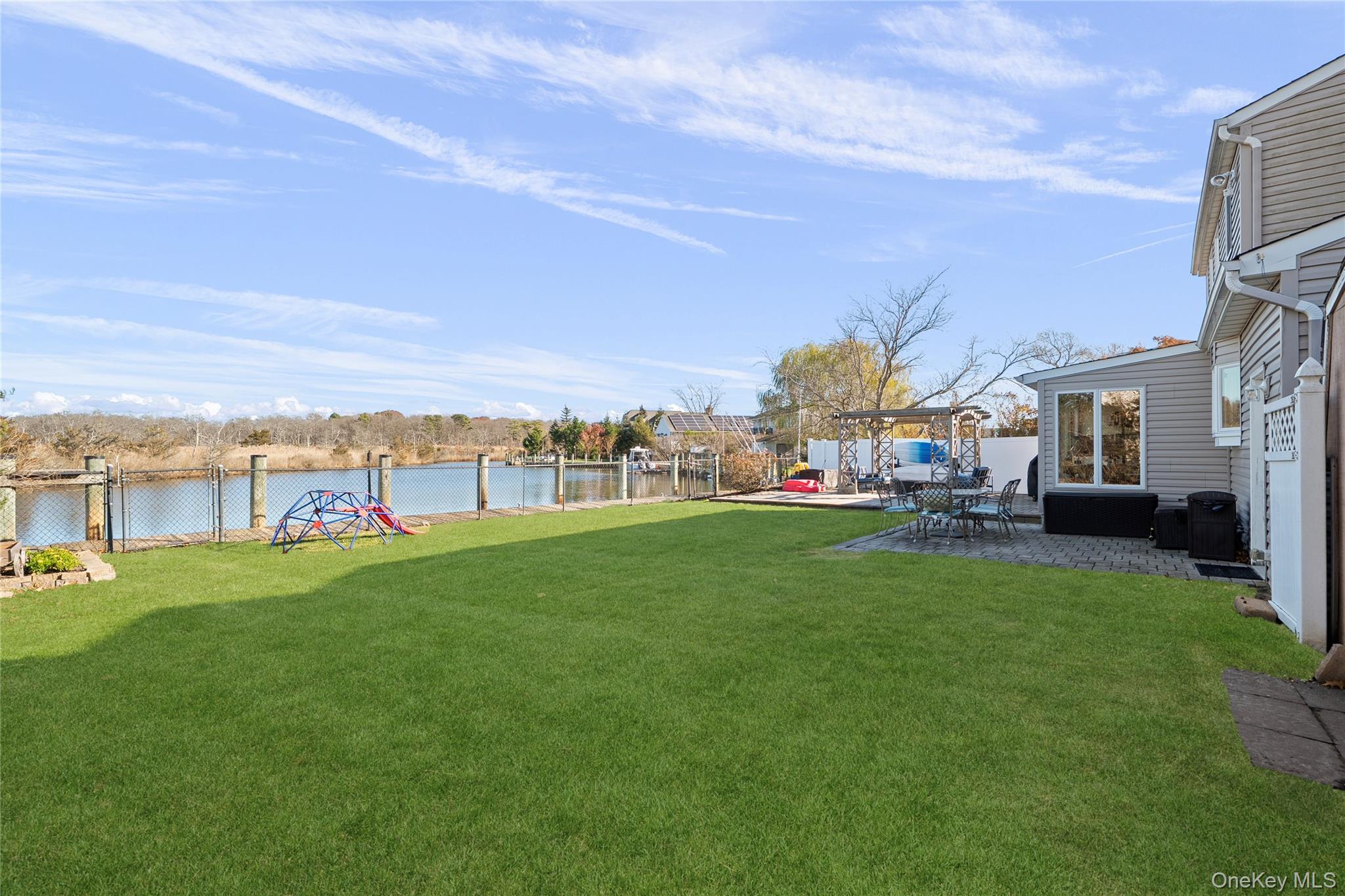 625 Edgewater Road Oakdale, NY 11769 - Photo 38 of 49 View of yard featuring a water view and a patio