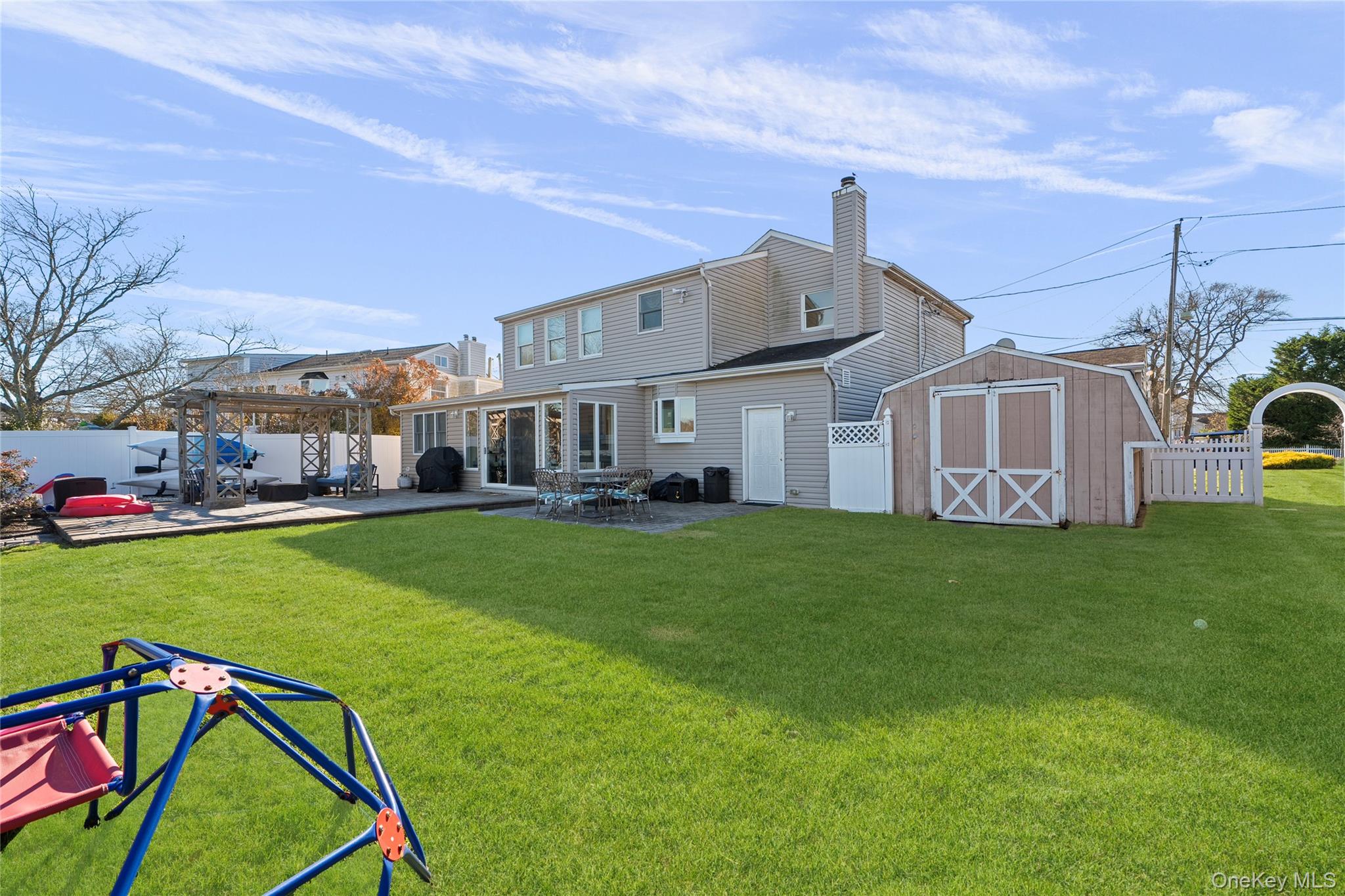 625 Edgewater Road Oakdale, NY 11769 - Photo 39 of 49 Rear view of property featuring a fenced backyard, a storage shed, a pergola, and a patio area