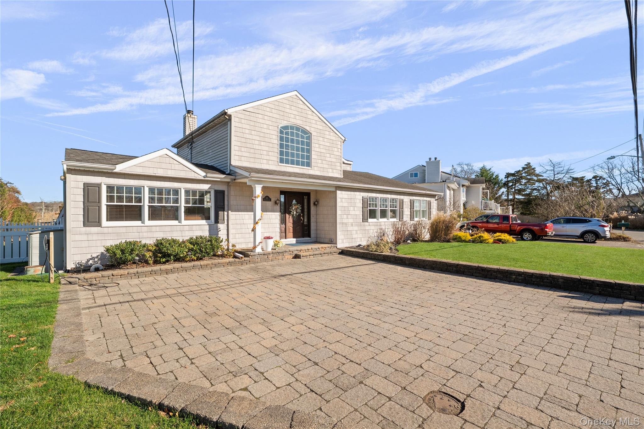 625 Edgewater Road Oakdale, NY 11769 - Photo 48 of 49 Traditional-style house with a front yard, a chimney, and roof with shingles