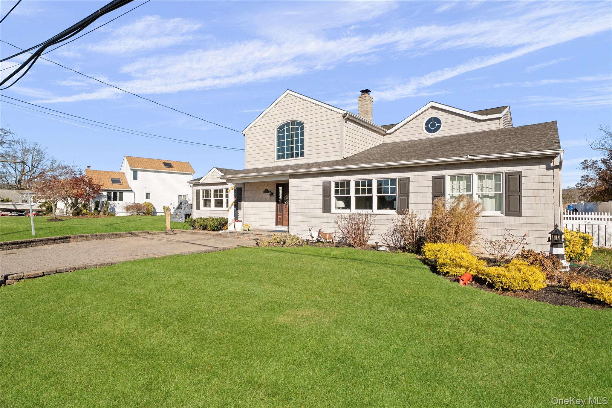 625 Edgewater Road Oakdale, NY 11769 - Photo 49 of 49 View of front of house featuring a chimney and a shingled roof