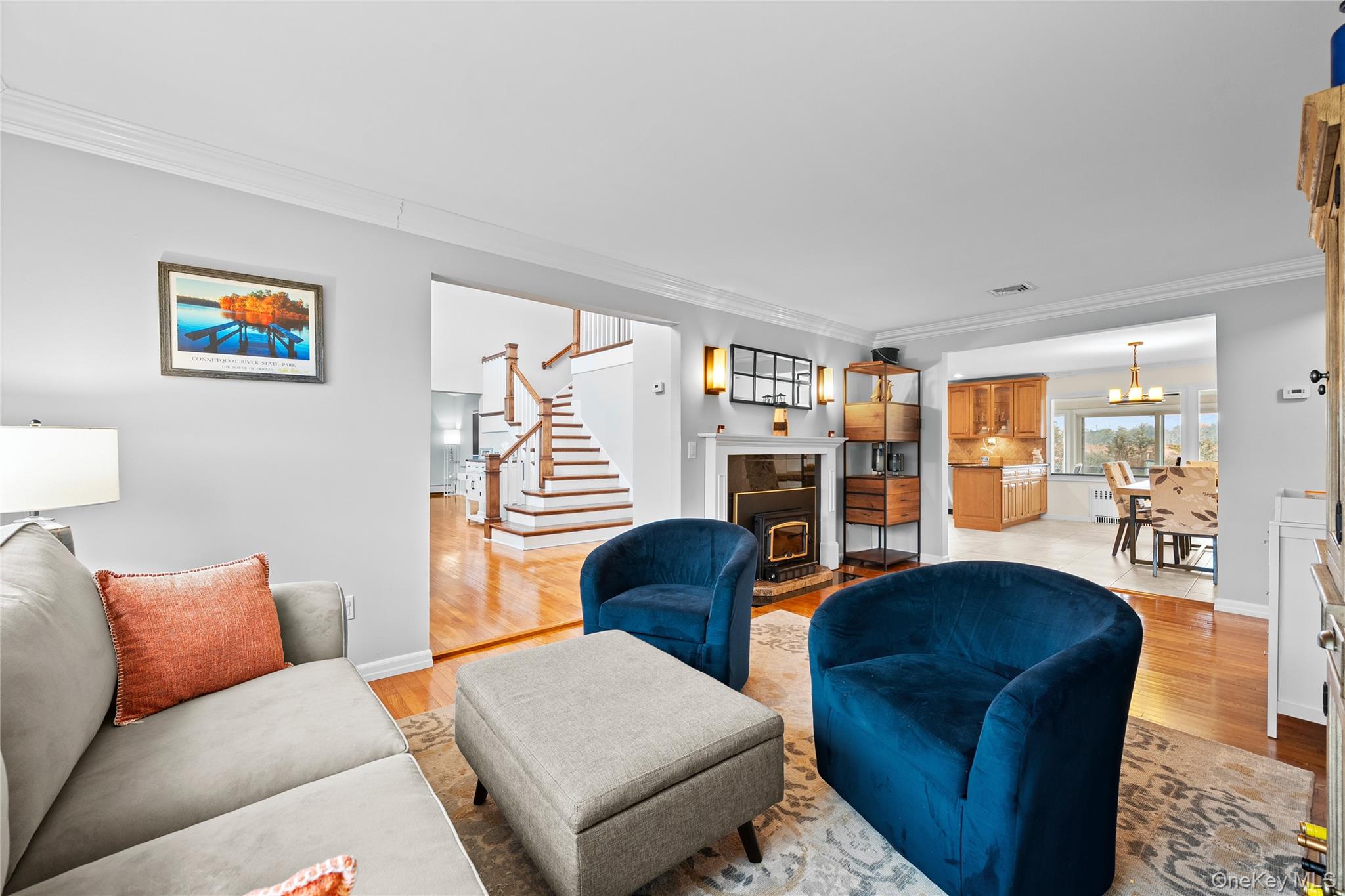 625 Edgewater Road Oakdale, NY 11769 - Photo 7 of 49 Living area featuring ornamental molding, stairway, and light wood-type flooring