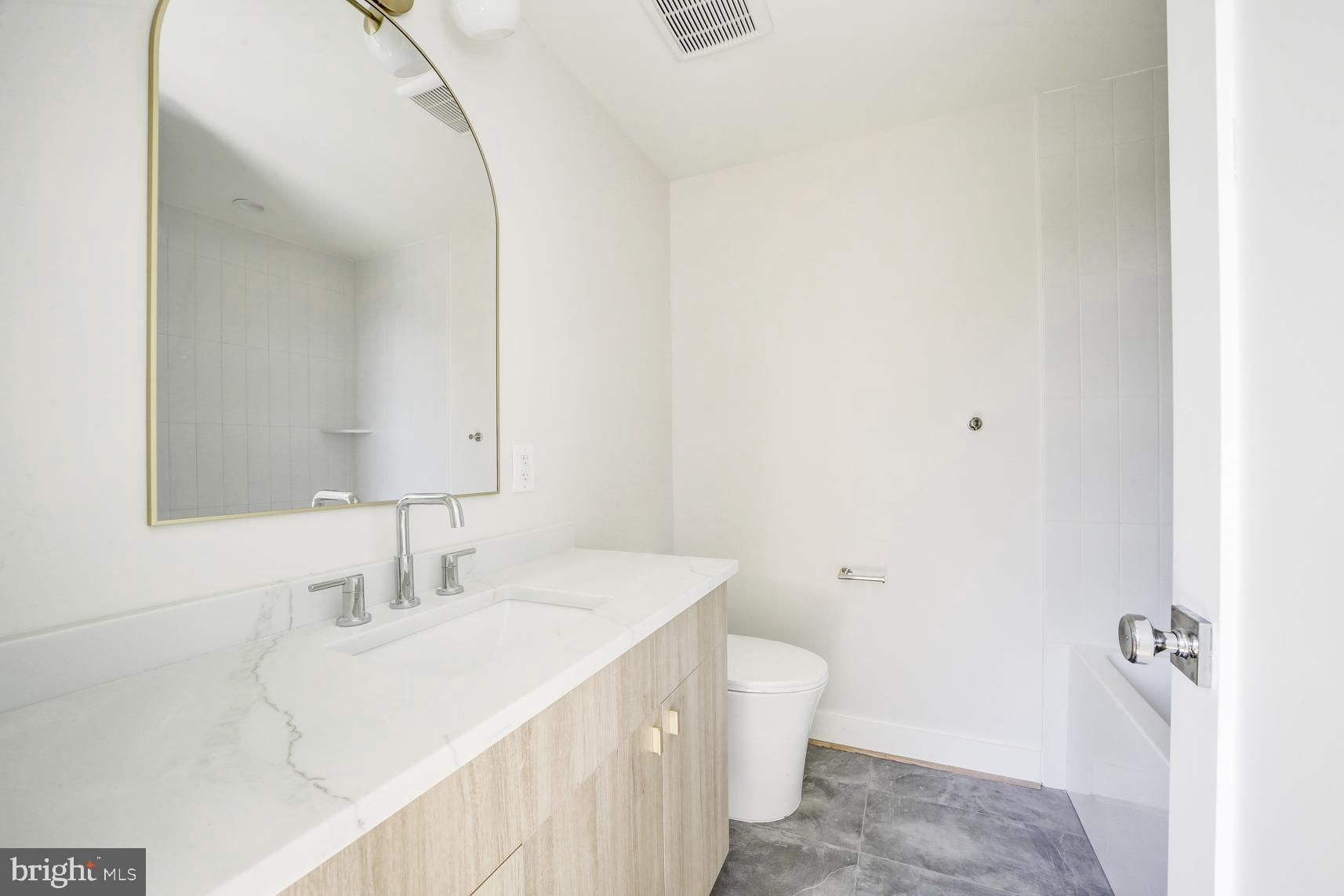 3118 Mt Pleasant Street Northwest, Unit 3 Washington, DC 20010 - Photo 14 of 16 a bathroom with a sink and a mirror