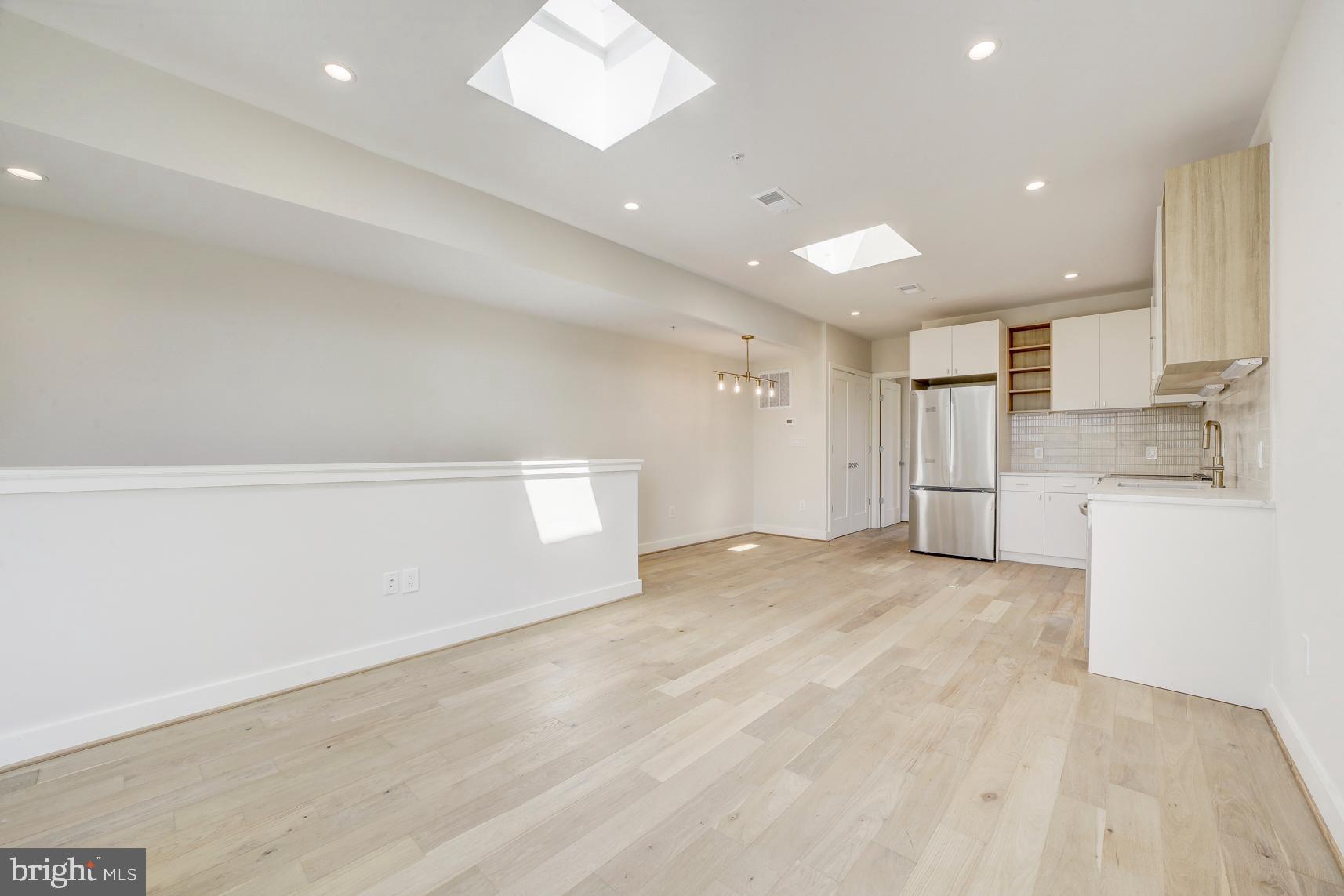 3118 Mt Pleasant Street Northwest, Unit 3 Washington, DC 20010 - Photo 3 of 16 a view of a kitchen with white cabinets