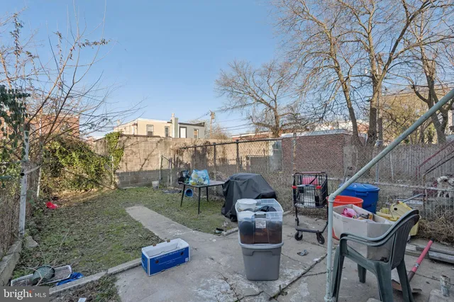 a view of a patio with table and chairs and potted plants