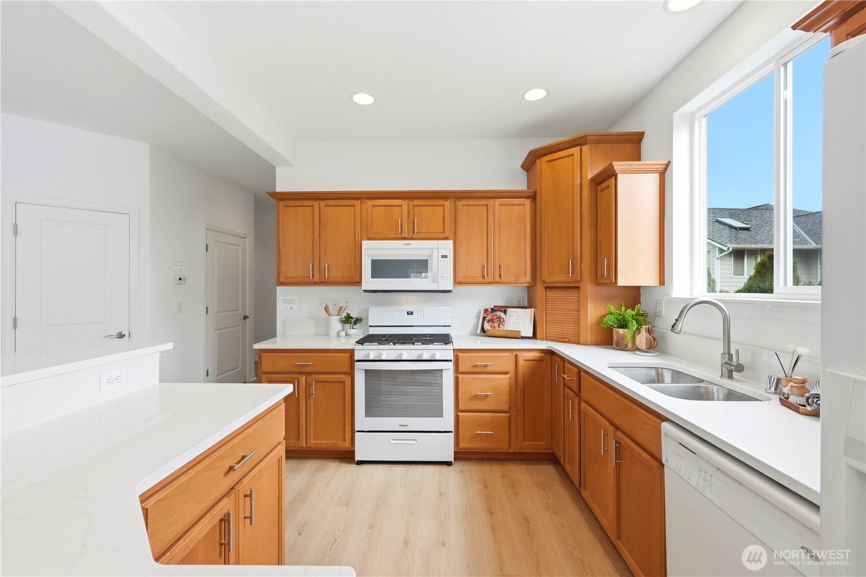 24115 22nd Place West Bothell, WA 98021 - Photo 17 of 40 a kitchen with a sink a stove a refrigerator and cabinets