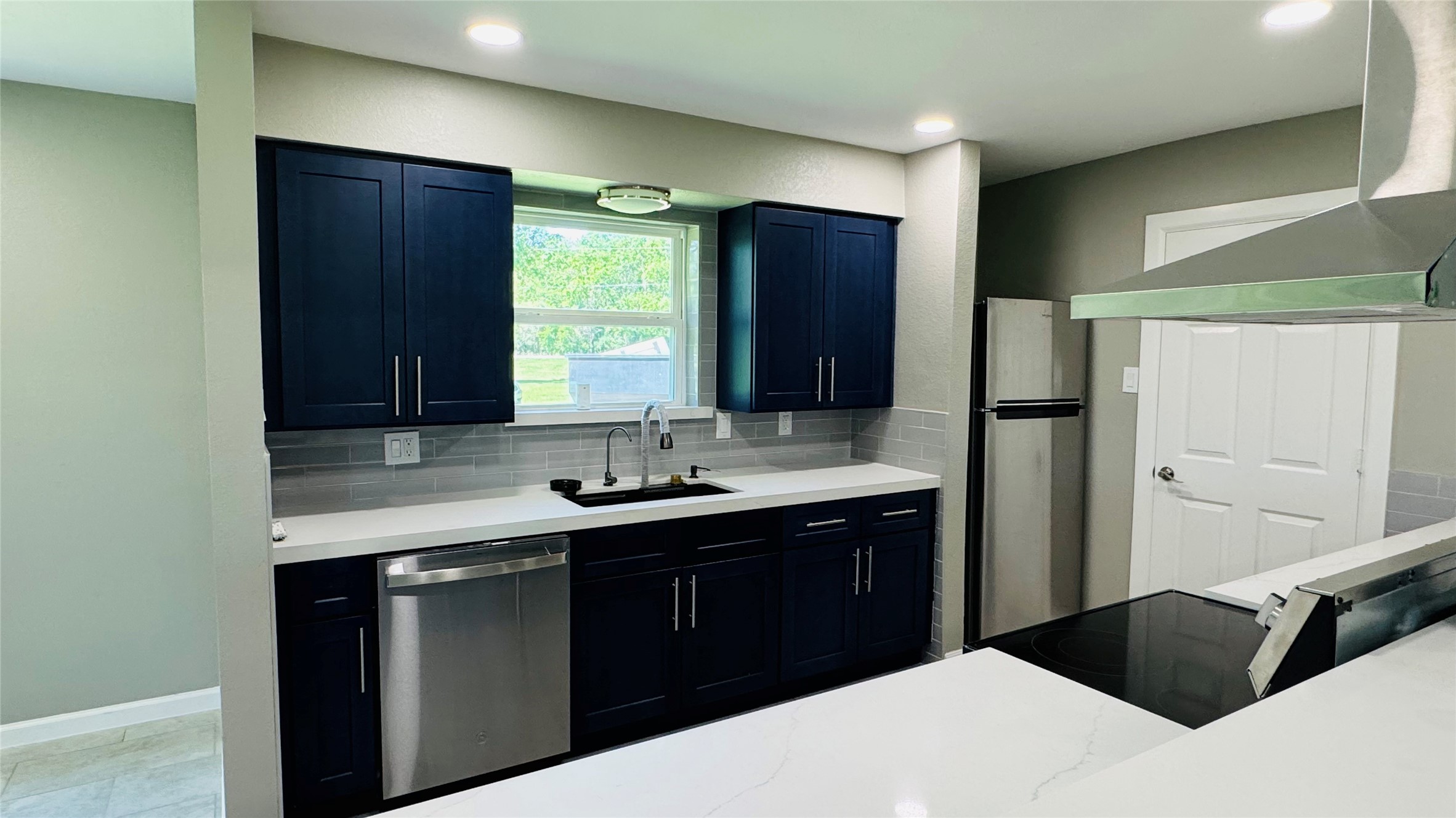 1434 County Road 878A Sweeny, TX 77480 - Photo 11 of 36 a kitchen with a sink and a refrigerator