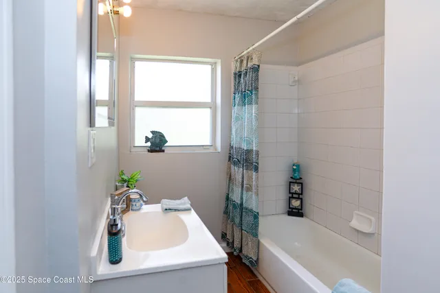 a bathroom with a sink and a bathtub with shower