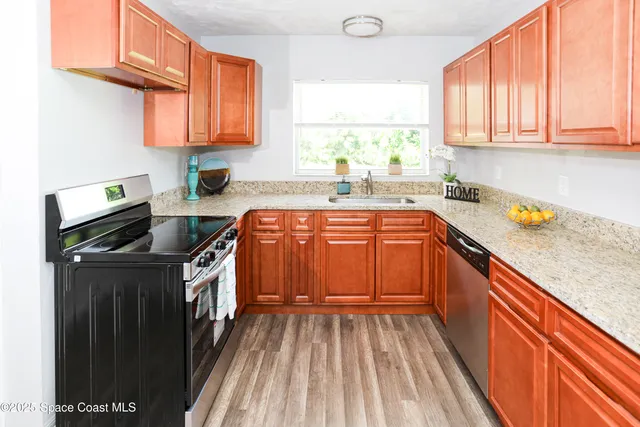 a kitchen with a sink stove and cabinets
