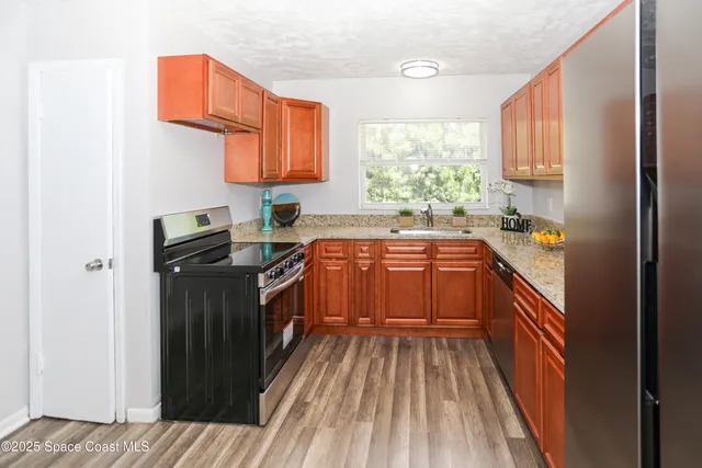 a kitchen with a sink stove and refrigerator