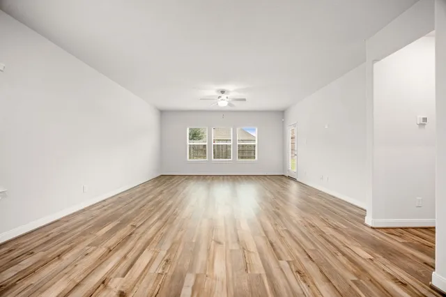 wooden floor in an empty room with a window
