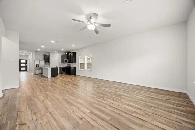 a view of kitchen and hall with wooden floor