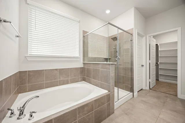a bathroom with a bathtub and a shower