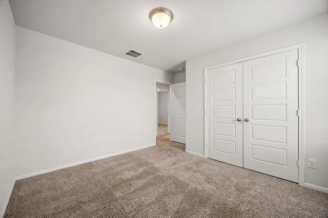 an empty room with closet area