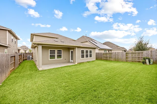 a view of a house with a yard and deck