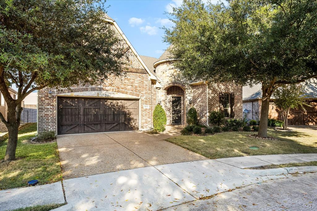 6814 Springwood Lane Garland, TX 75044 - Photo 31 of 35 a front view of a house with a yard and garage