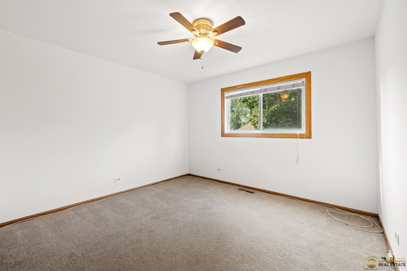 26235 North Acorn Lane Mundelein, IL 60060 - Photo 14 of 24 an empty room with a window and a ceiling fan