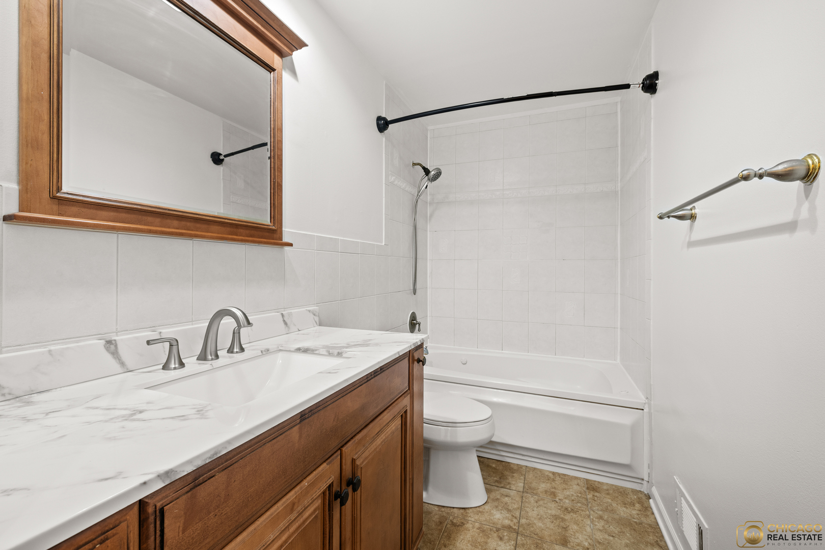 26235 North Acorn Lane Mundelein, IL 60060 - Photo 16 of 24 a bathroom with a sink a toilet and shower